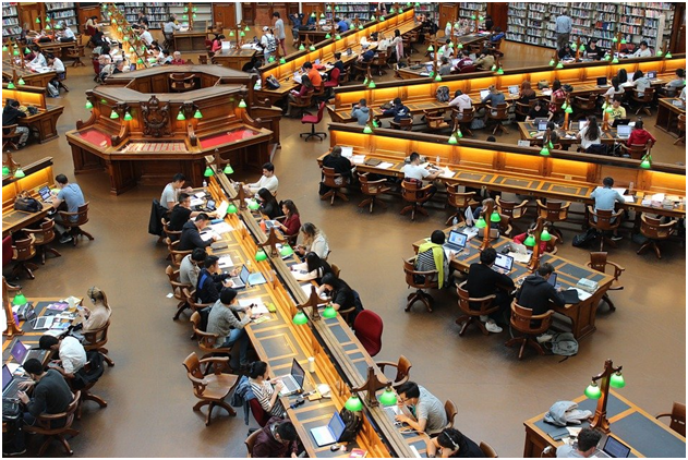A library with lots of students studying for exams